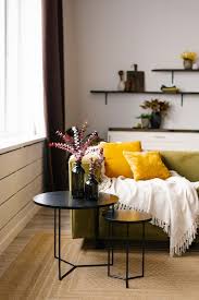 A Green Sofa With Yellow Pillows And A