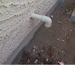 water leaks pipe on side of house