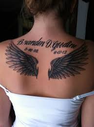 Grey ink stone cross with angel wings tattoo on back body. Angel Tattoos For Women Ideas And Designs For Girls