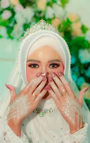 a beautiful bride in white hijab while