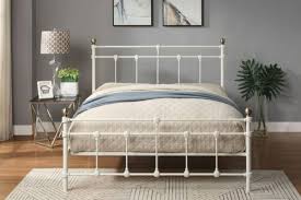 white and brass metal bed frame