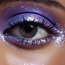 a purple glitter eye makeup with a