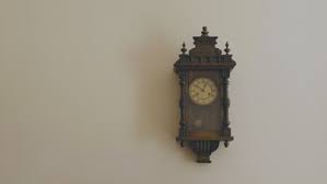 Antique Grandfather Clock Hanging On A