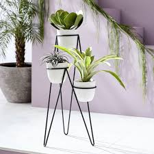 Perfect for both indoor and outdoor areas, a simple white or black planter is an easy way to spice up any room. Iris Indoor Outdoor Planter Chevron Stand Triple