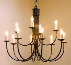 This substantial black chandelier offers an unadorned minimalist silhouette consisting of a large iron ring with four iron rods extending upward in a pyramidal shape. Hartcliff 12 Light 800mm Wrought Iron Chandelier Hartcliff Wrought Iron Chandeliers
