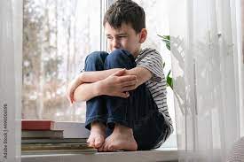 boy is sad alone at home photos