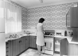 a woman uses kitchen facilities in