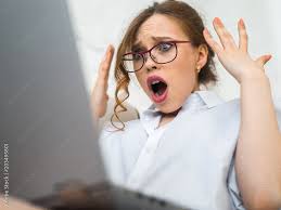 Surprised bwoman looking at camera, astonished woman with shocked face and  open mouth holding laptop. Stock Photo | Adobe Stock