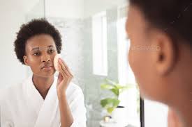 woman applying makeup to her face while
