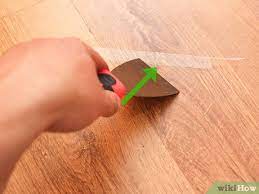 remove adhesive from a hardwood floor