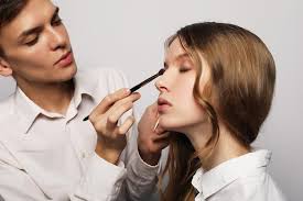 makeup artist young male doing makeup