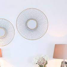 Gold Metal Wall Art With A Round Mirror