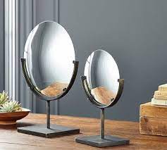 round bronze mirror on stand