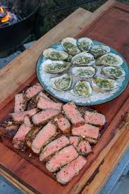 grilled steaks and oysters over the