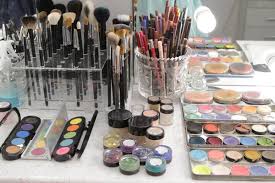 sets of makeup brushes and cosmetics on