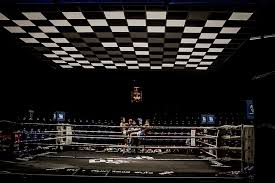man fighting on square boxing ring