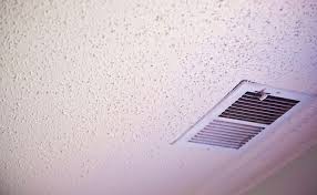 how to clean a popcorn ceiling the maids