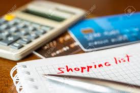 Calculation Of Costs A Notebook With Shopping List And A Credit