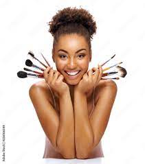 young woman with makeup brushes