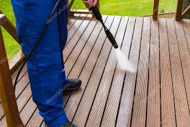 cleaning wooden terrace with high