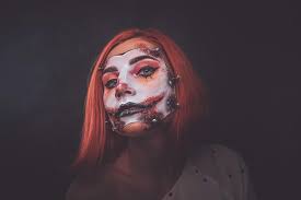 scary dead doll makeup is posing