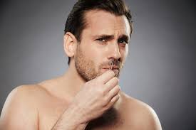 Premium Photo | Scared man removing nose hair with tweezers
