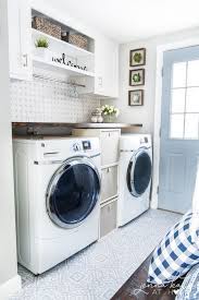 Laundry area with white cabinets, washer and dryer, clothes hanging on rack on built in shelf, storage compartments, and wicker laundry basket on floor. 24 Best Laundry Room Ideas Clever Laundry Room Storage Ideas