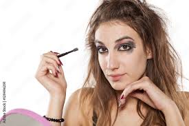 young woman in a mirror and ugly makeup