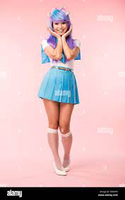 Full length view of otaku girl in purple wig smiling on pink Stock Photo -  Alamy