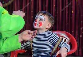young boy putting mime makeup for a