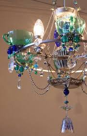 This chandelier is made completely of recycled objects. Upcycled Chandeliers Homemade Chandelier Diy Chandelier Creative Lighting
