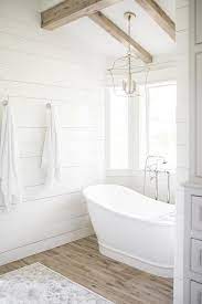 cottage bathtub alcove with plank walls