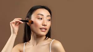 young korean lady with makeup brush