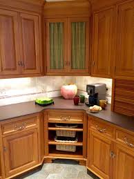 Entirely remove the door from the corner cabinet, then install those large hooks in the top surface of the cabinet to hang pots and pan. 5 Solutions For Your Kitchen Corner Cabinet Storage Needs