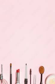 various cosmetics on a pink background