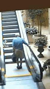 old man falling down escalator