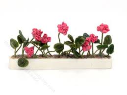 white window box with pink flowers for