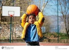 cute little boy holding a basket ball