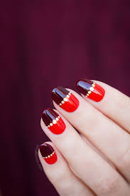 red nail design with magic gold