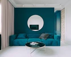 teal accent wall and teal couch