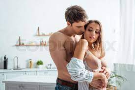 muscular man hugging sexy woman with big breast | Stock image | Colourbox