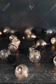 Led String Lights In Shape Of Lightbulb Scattered On Wooden Tabletop