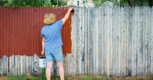 Painting A Fence In The Rainy Season