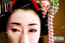 a woman made up in traditional geisha