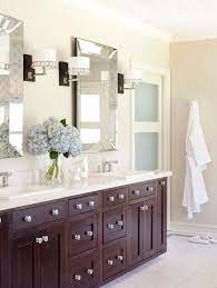 Sophisticated bathroom features a black vanity topped with white quartz placed under a nailhead mirror, pottery barn farrah nailhead mirror, illuminated. Pottery Barn Bathroom Mirror Contemporary Bathroom Sherwin Williams Wool Skein Tobi Fairley