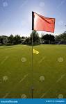 Flag Blocking Sun on Golf Course - Vertical Stock Photo - Image of ...