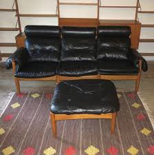 black leather three seater sofa with