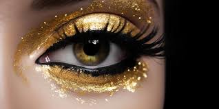 a gold eye makeup with gold glitter on
