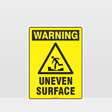 warning uneven surface sign notice