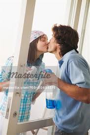 Couple Kissing Through Glass Door